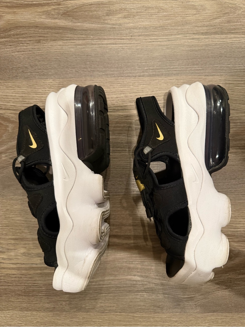 Nike Kids Black and White Sandals with Gold Swoosh Accent